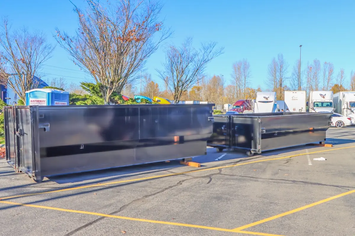 Professional dumpster rental service with roll-off container on residential driveway in Randolph Town
